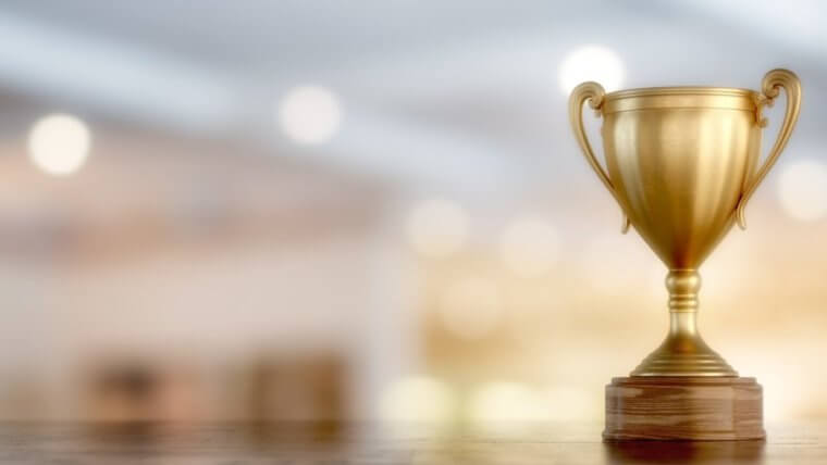 Image of golden bronze trophy with a blurred out background to represent home builder awards.