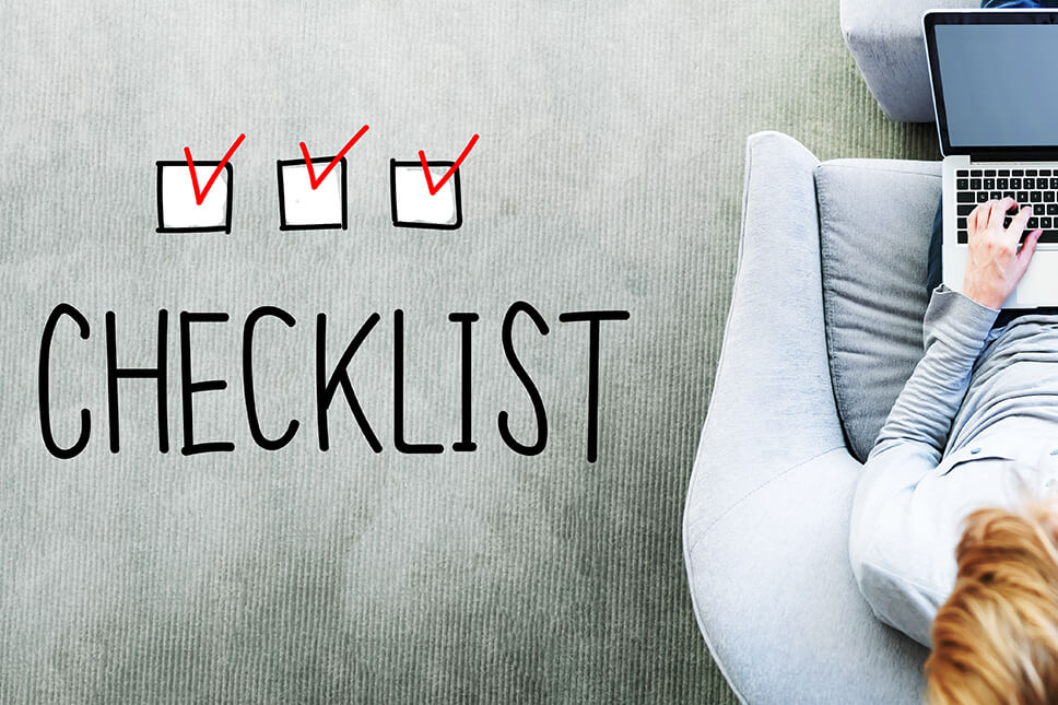 Lady with checklist photo for the ultimate guide to choosing the right builder blog